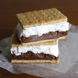 Frozen s'mores! Layers of chocolate pudding and marshmallow cheesecake sandwiched between graham crackers and frozen for the perfect summer treat. Super easy recipe!