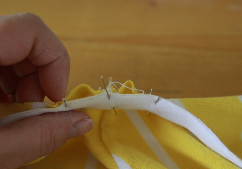 White knit strip pinned into edge of sleeve, bunching up fabric
