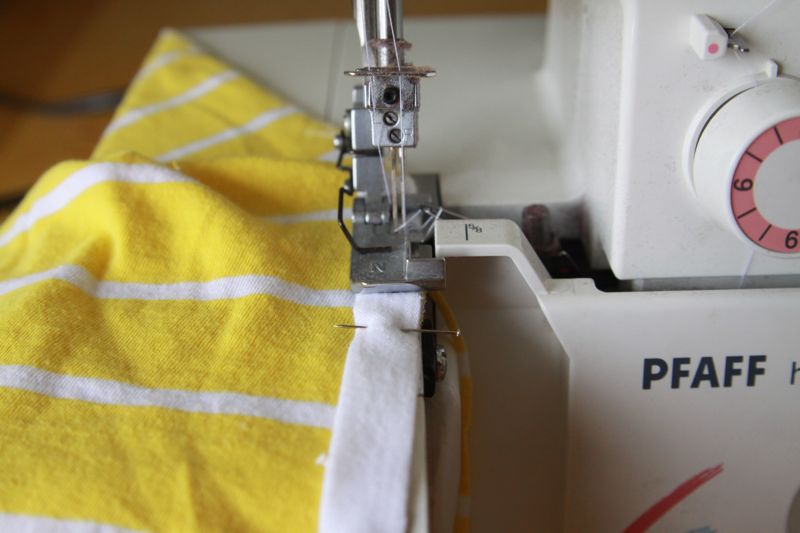 sewing on white fabric strip on sewing machine