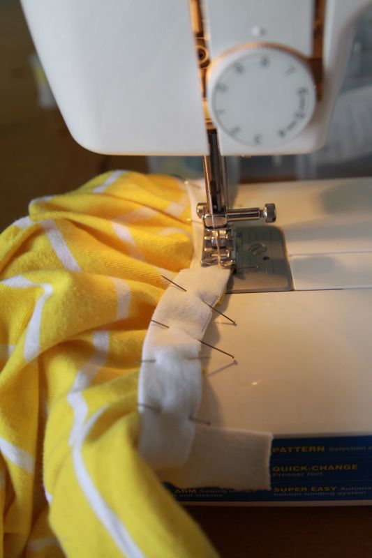 sewing binding that\'s pinned to dress, with fabric under binding bunched