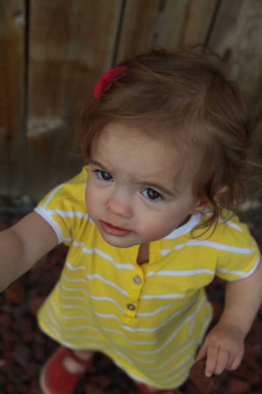 A small child wearing a yellow dress