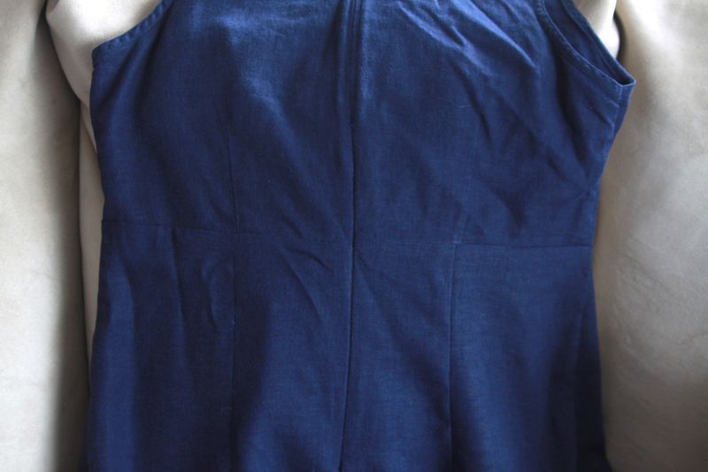 Back of navy dress with invisible zipper and darts