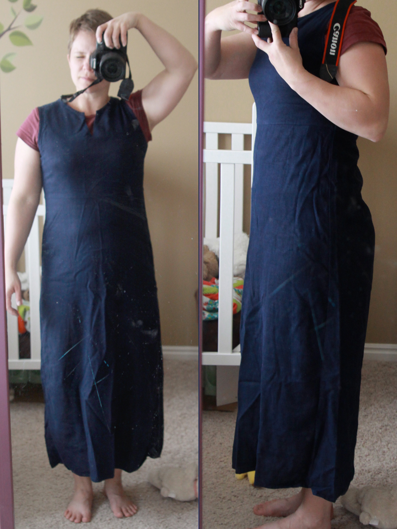 A woman wearing a long navy dress taking a selfie