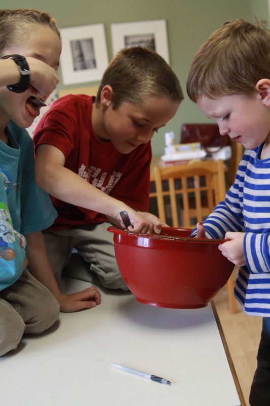 kids eating brownie batter from a bowl