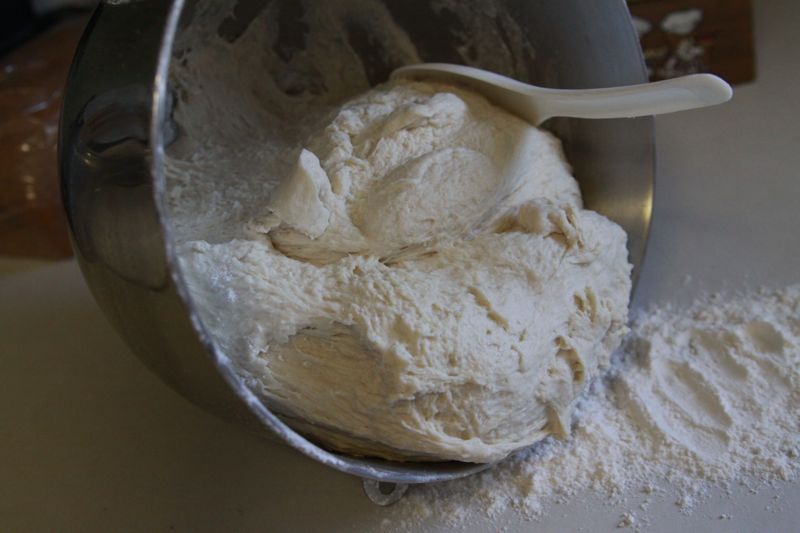 dough being turned out of mixer bowl onto floured countertop