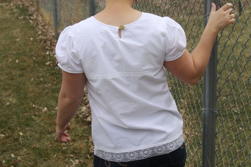 A woman wearing a white blouse, back view
