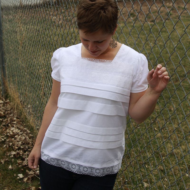 A woman wearing a white Anthropologie inspired blouse