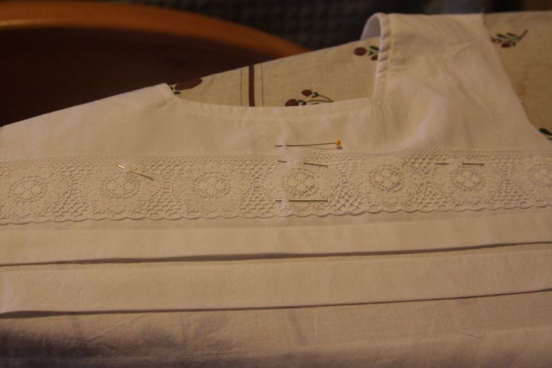 lace pinned across front of blouse