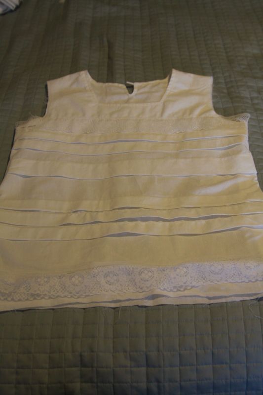 pleated front of blouse with lace pinned across it