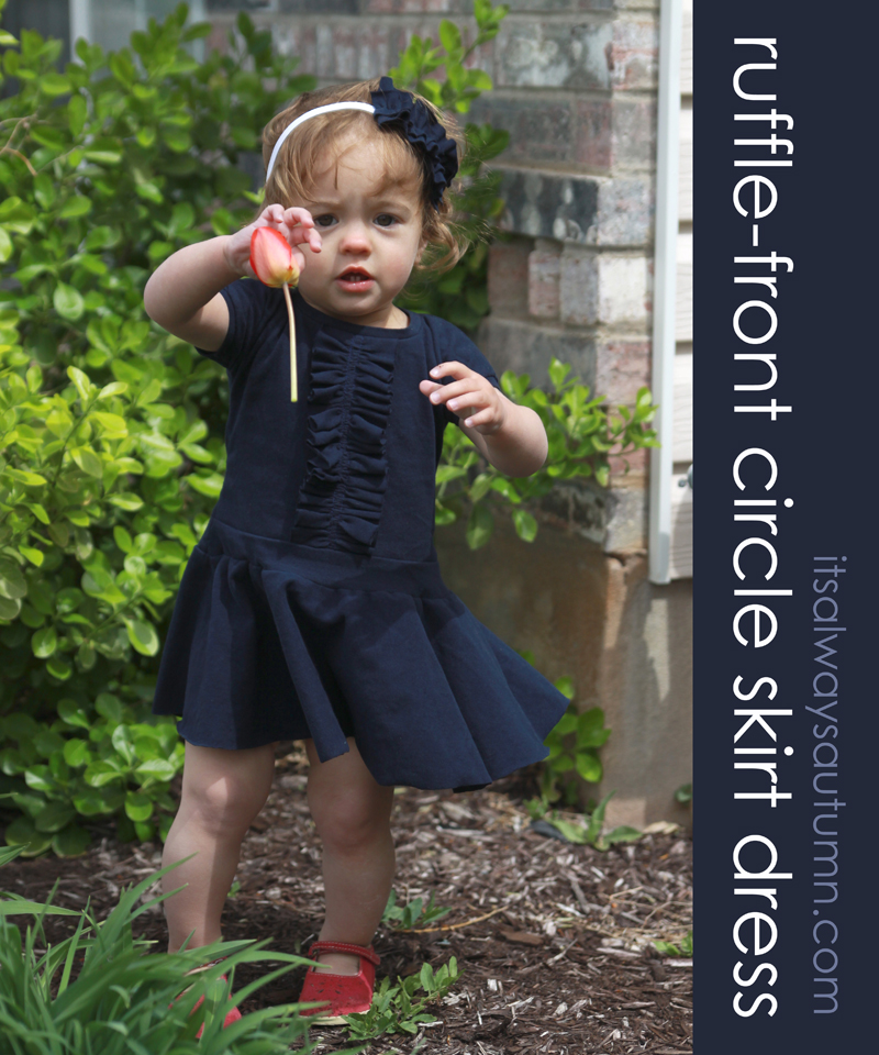 A little girl wearing a ruffle front circle skirt dress