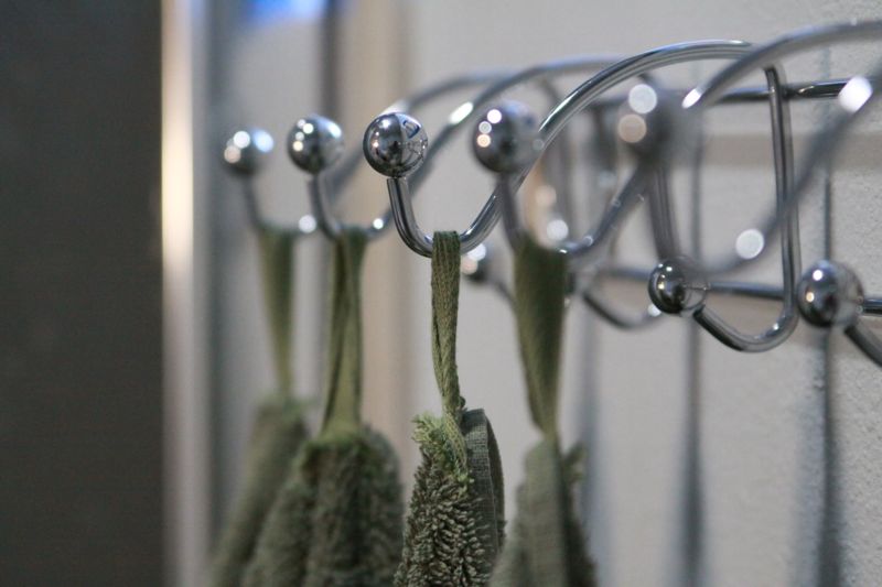 closeup of hooks with towels hanging from them
