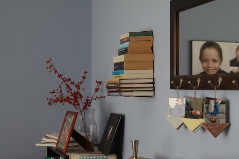 books on invisible bookshelf on a wall