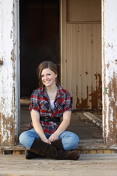 A girl sitting in the doorway of an old building