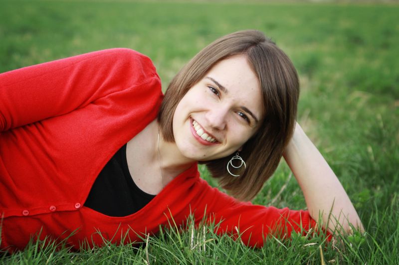 A closeup photo of a girl leaning her head on her hand