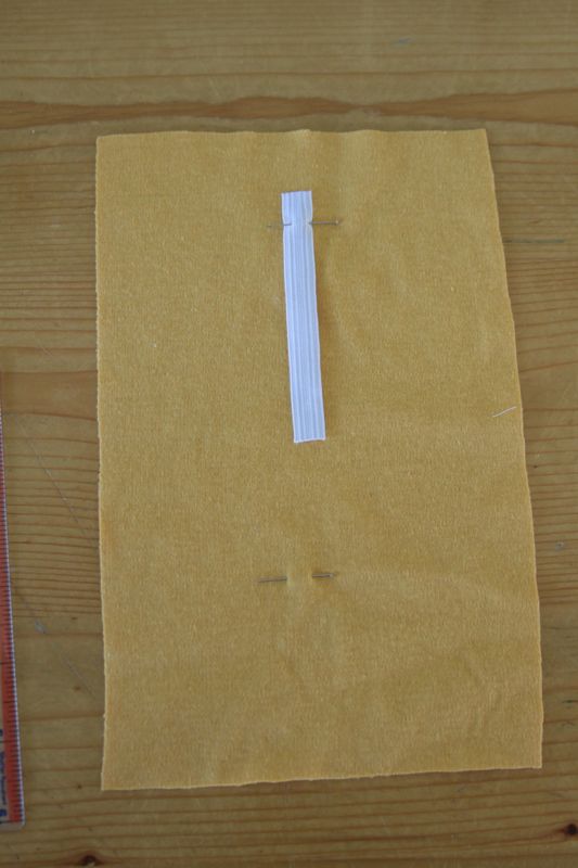 Elastic strip pinned to yellow fabric at top pin
