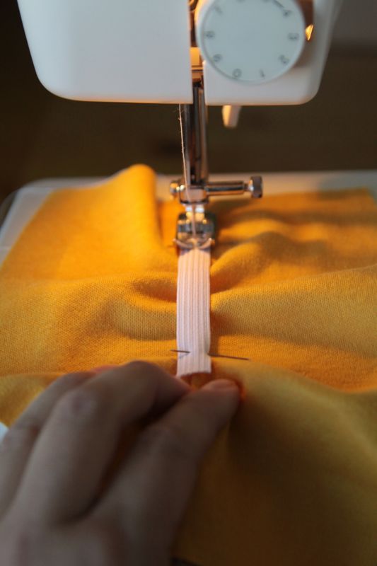 yellow fabric and elastic on sewing machine