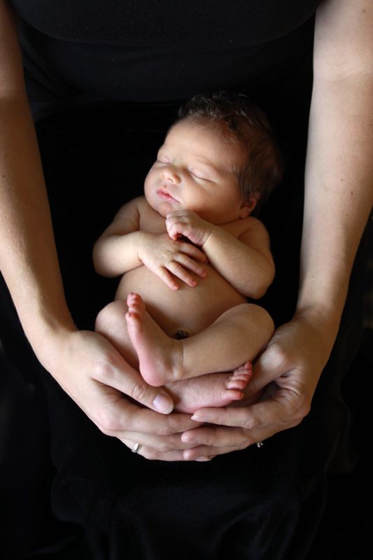 Hands holding a newborn baby