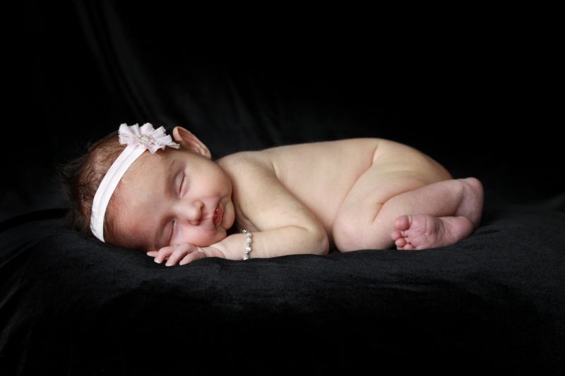 A newborn baby laying on a blanket