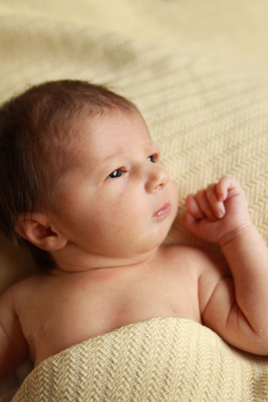 A baby lying on a bed