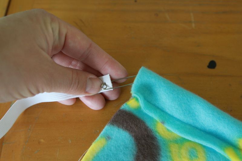 Hand threading elastic through casing using a safety pin