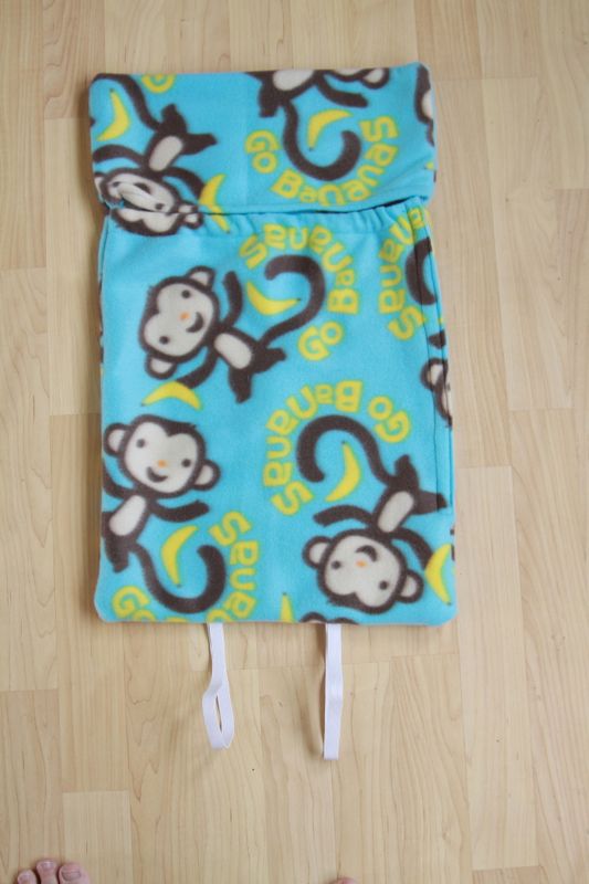 Sleeping bag sewn together, with elastic loops at the bottom and velcro along one side