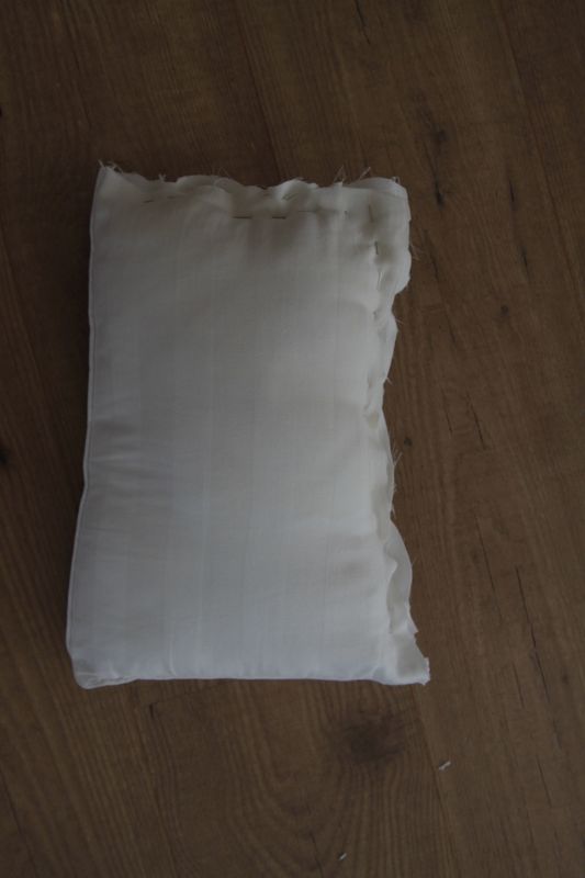 Small piece of pillow with side sewn shut