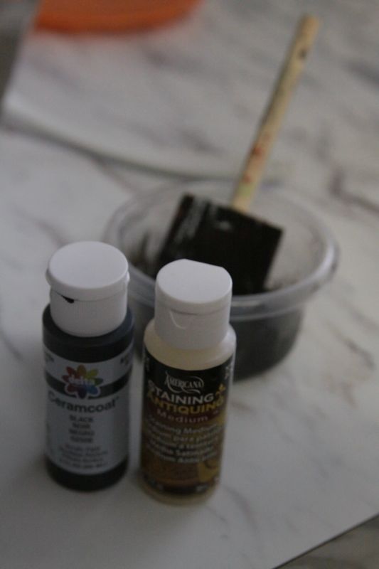 black paint and antiquing liquid, with bowl and foam paintbrush