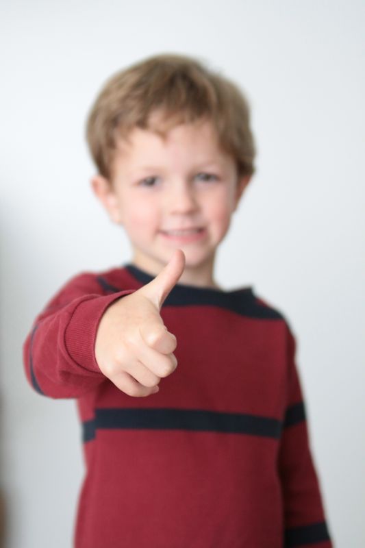 little boy giving a thumbs up