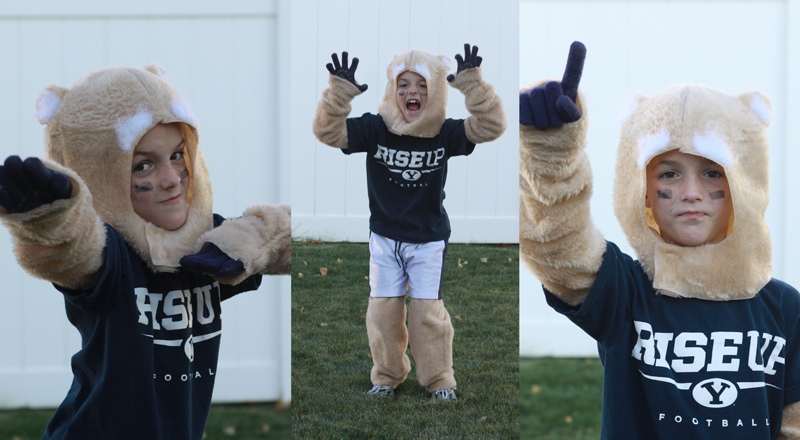 Little boy playing in a Cosmo cougar football mascot costume
