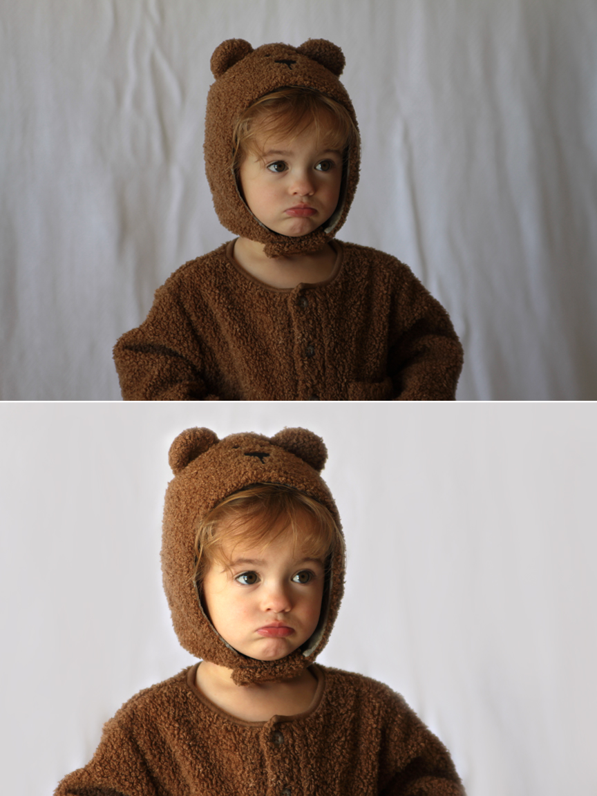 A little girl in a bear costume in front of a wrinkled background; same photo with a smooth background
