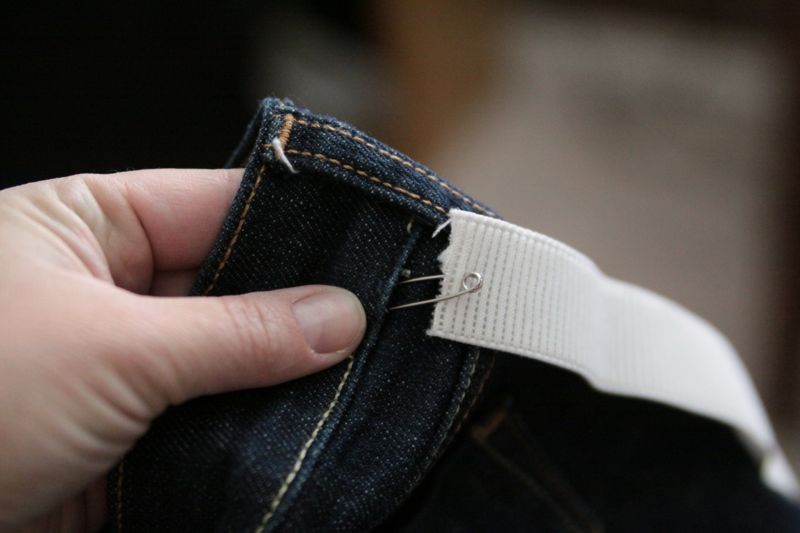 Using safety pin to thread elastic into the back waistband of jeans