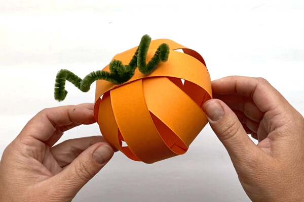 Pipe cleaner threaded through all holes to make a pumpkin shape