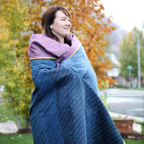 A person wrapped in a demin quilt