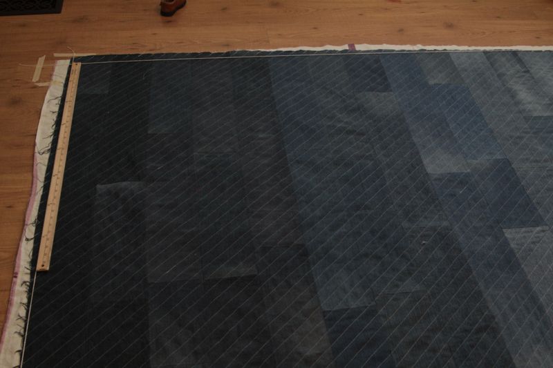 Denim quilt with diagonal quilted lines, laid out to trim edges square