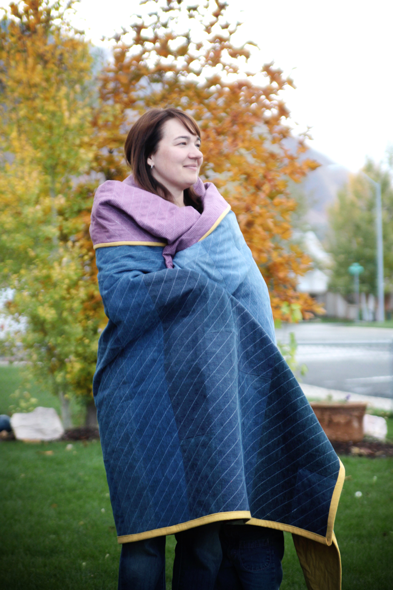 A person wrapped in a DIY jeans quilt