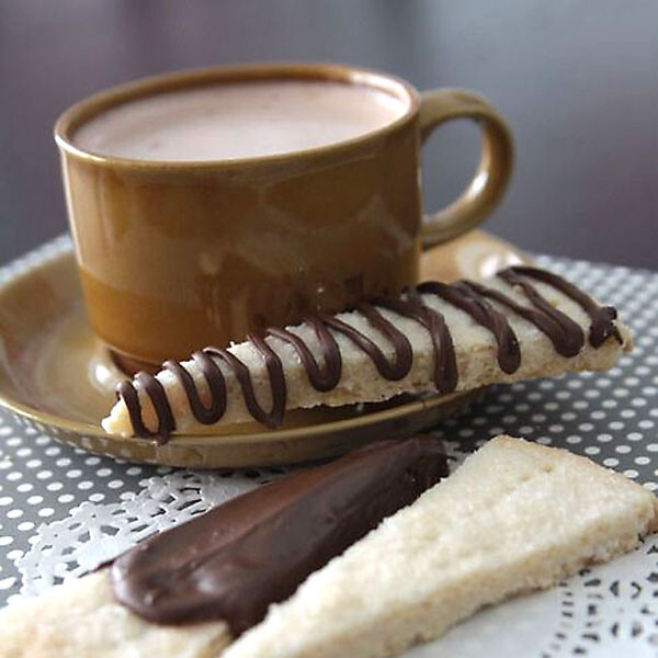 A cup of cocoa on a table, with Shortbread slices