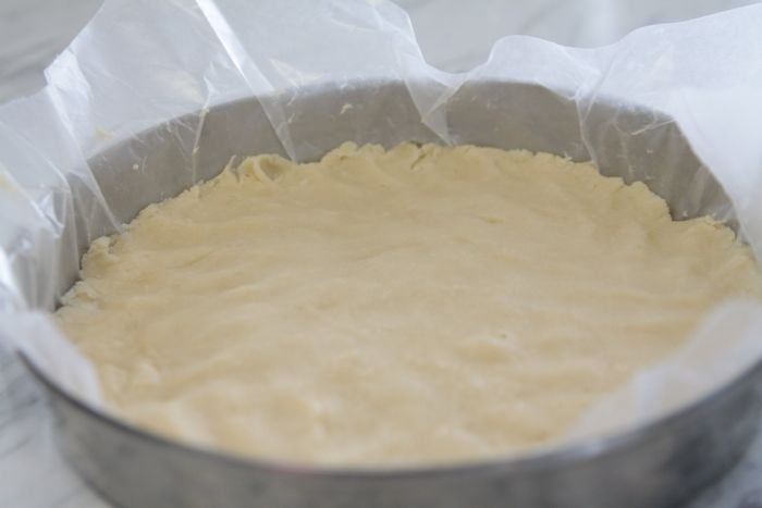 shortbread dough pressed into round cake tin