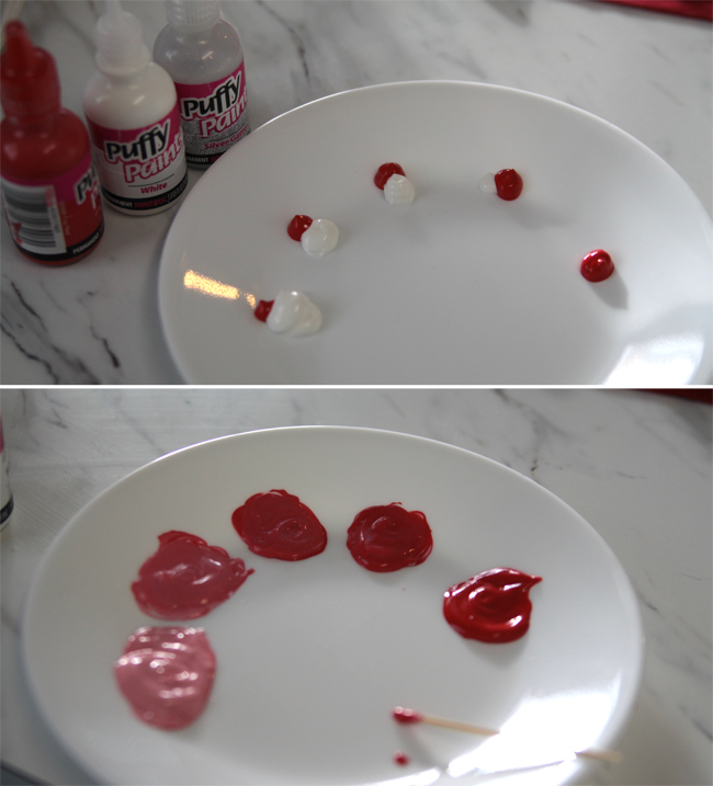 A close up paint on a plate in different shades of red and pink