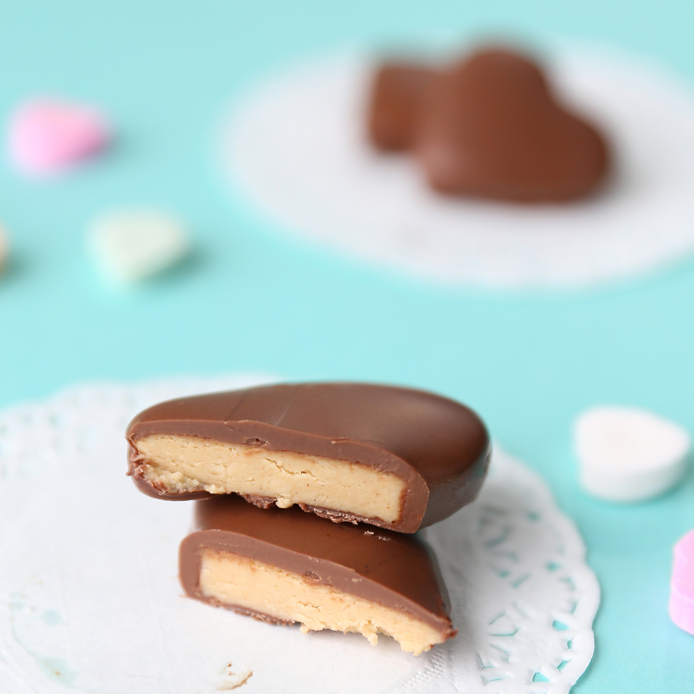 Peanut butter and chocolate heart cut in half and stacked on a doily