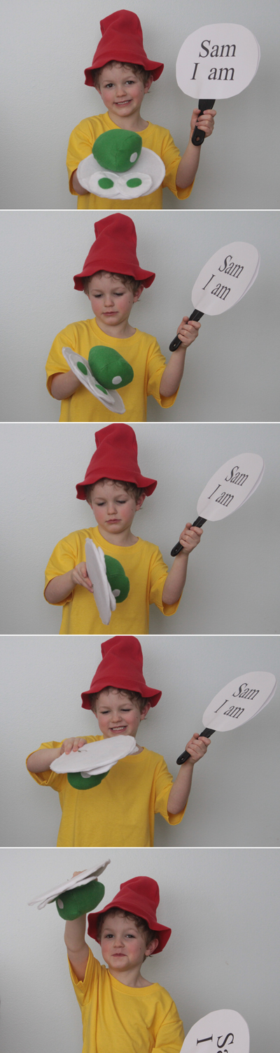 A young boy wearing a Green Eggs and Ham Dr. Suess costume