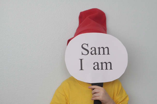 A boy holding a sign that says Sam I am