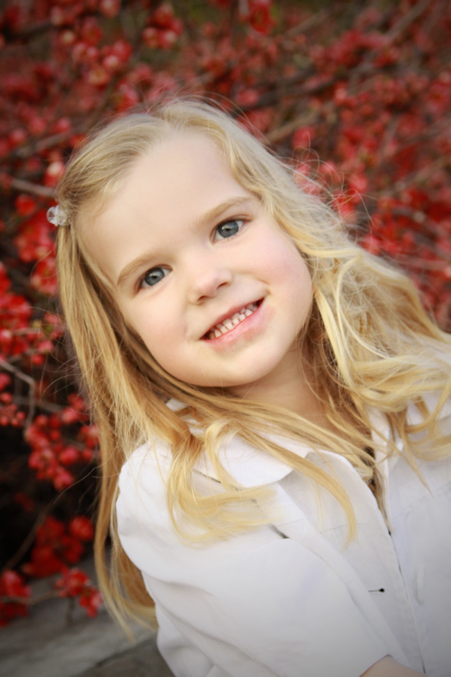 A toddler smiling at the camera