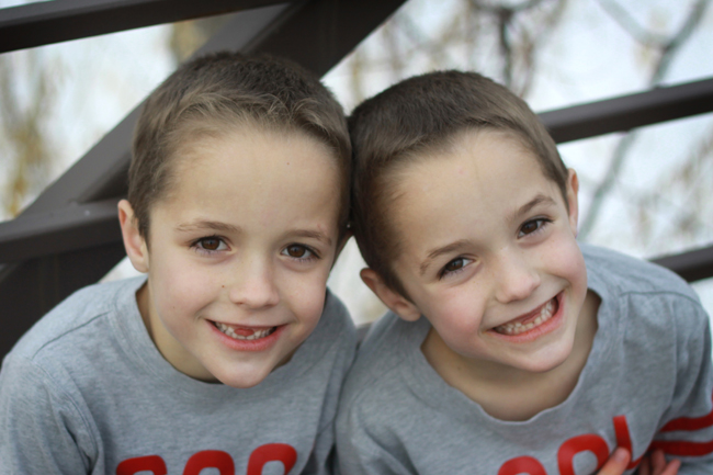 well lit photo of boys outside on a bridge