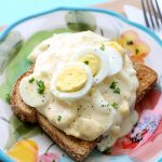 Hard boiled eggs in a creamy white sauce over toast