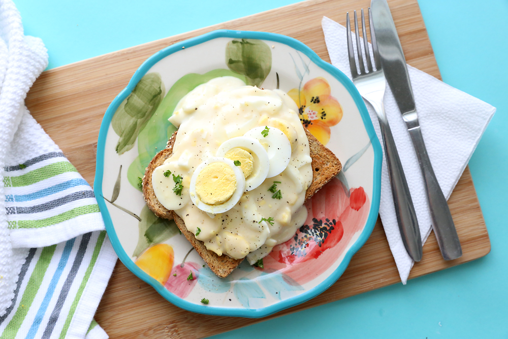 Creamed eggs over toast on a plate