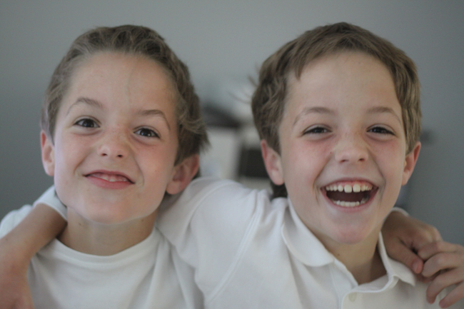 A close up of two young boys laughing