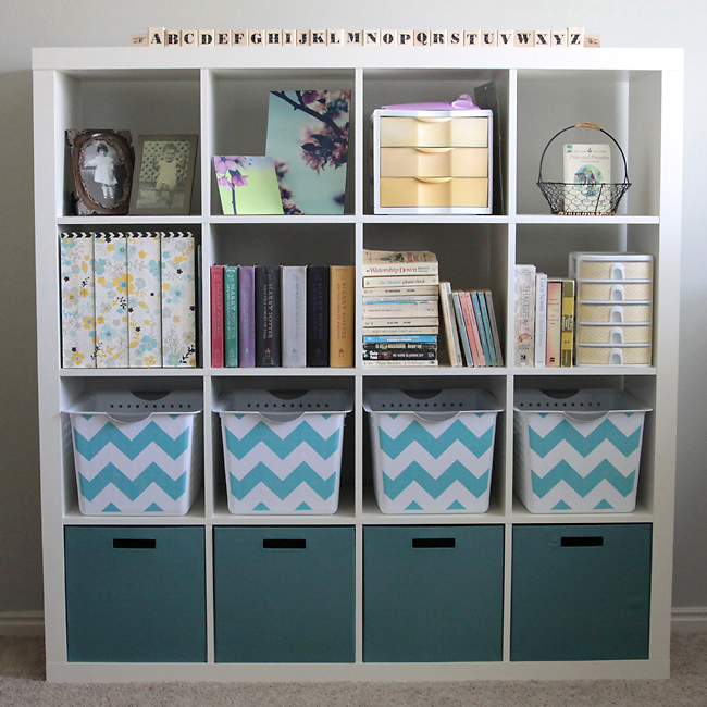 Cube storage unit filled with photos, book, bins