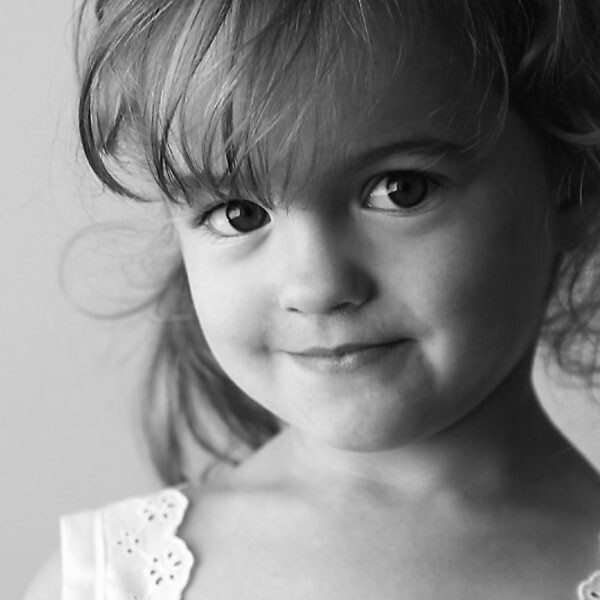 black and white photo of a young girl smiling