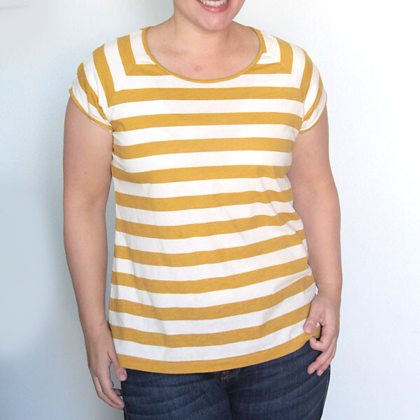 a woman wearing the easy tee with raglan sleeves and yellow and white stripes