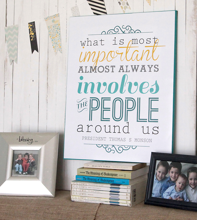 Printable quote sign on a stack of books with family photos
